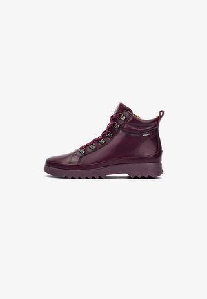 Maroon leather high-top shoes with a rugged sole, metallic eyelets, and contrasting laces, featuring a padded collar for comfort.
