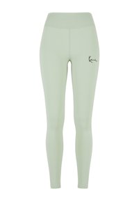 Leggings vert clair avec taille haute, fabriqués en matière extensible. Équipés d'un logo noir sur la cuisse gauche. Texture lisse, design pleine longueur.