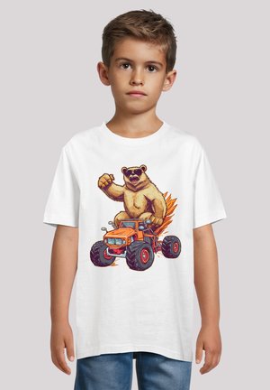 White short-sleeve t-shirt featuring a graphic of a bear in sunglasses on an orange monster truck, with black wheels and fiery accents.