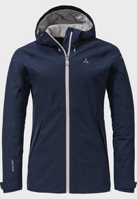 Marineblaue wasserdichte Jacke mit silbernem Reißverschluss an der Vorderseite, verstellbarem Kapuze, seitlichen Taschen und dezentem Logo-Detail am Ärmel. Glatte Textur.