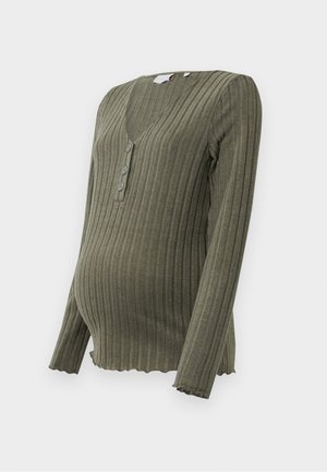 Olive green ribbed maternity top with long sleeves, V-neck, and three-button placket. Scalloped hemline adds texture and detail.