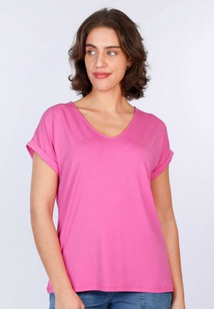 Short-sleeve pink V-neck T-shirt made from soft fabric, featuring rolled sleeves and a relaxed fit. Styled with casual blue jeans.