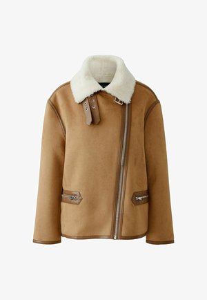 Brown shearling jacket with a white fur collar, side zip pockets, and leather accents. Features a front zipper closure and a boxy silhouette.