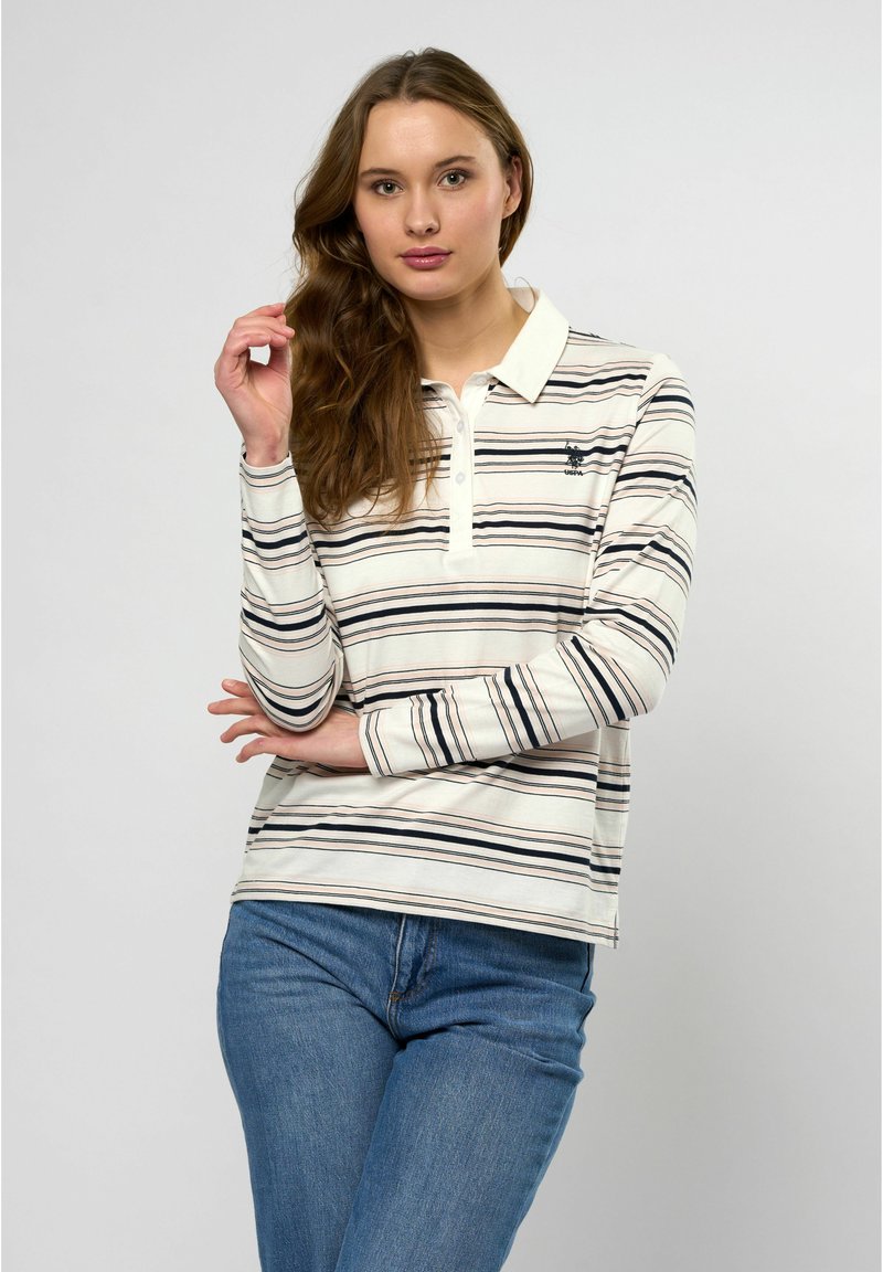 Lange mouwen polo-shirt in crème met marineblauwe strepen, met een puntige kraag en een klein logo op de linkerborst. Geweven katoen stof.