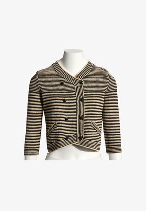 Cardigan court rayé noir et beige avec manches longues, fermeture croisée à boutons et deux poches devant sur un mannequin blanc.