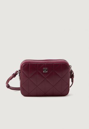 Prošívaná burgundská taška vyrobená z lesklého materiálu s akcentem stříbrného loga, na zip, s nastavitelným popruhem. Kompaktní obdélníkový design.