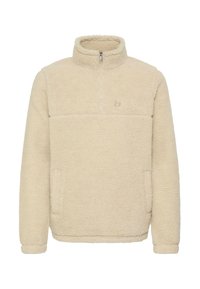 Sælgeren er en kræsset fleecepullover i cremet farve med halvlukket krave, elastiske manchetter og sidelommer; den har struktureret, blød stof og et logo på brystet.