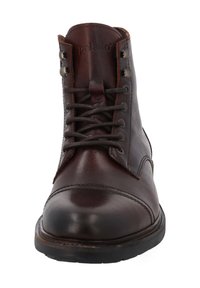 Bottine en cuir marron avec un bout arrondi, laçage à l'avant, œillets en métal et surpiqûres sur le dessus. Semelle en caoutchouc solide.