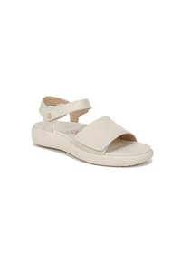 Light beige sandal made of soft leather with a thick sole. Features two wide straps, a back strap, and a small gold accent. Textured footbed.