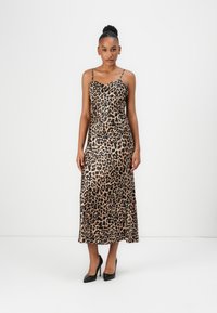 Leopard print midi dress with thin spaghetti straps, a fitted bodice, and a flowing skirt. Made from a satin-like material, featuring a smooth texture.