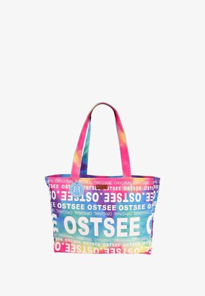 Multicolored tote bag featuring a tie-dye design with "OSTSEE" printed in white. Made from fabric with two sturdy handles.