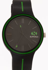 Black wristwatch with a dark gray face, green accents, and green markers. Smooth band with a contrasting green stripe. Features minimalist design.