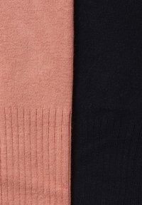 Two pairs of socks: one in soft pink and the other in dark black. Both feature a ribbed texture and smooth knit fabric.