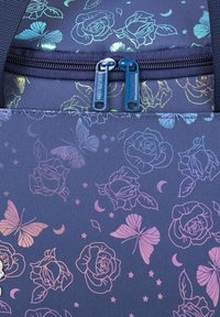 Navy fabric backpack with rose and butterfly patterns in iridescent colors. Features dual blue zippers and a textured surface.