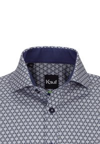 Camicia blu navy con un motivo geometrico bianco, colletto scuro a contrasto e due bottoni sul davanti. Etichetta con la scritta "Kauf," taglia 38.