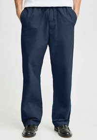 Navy blue, lightweight pants with a drawstring waist, side pockets, and a straight-leg design, suitable for casual wear.