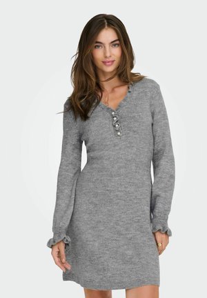 Abito lavorato a maglia grigio con maniche lunghe, scollatura a V e dettagli con bottoni. Le maniche arricciate aggiungono texture. Tessuto morbido e flessibile adatto per essere sovrapposto.