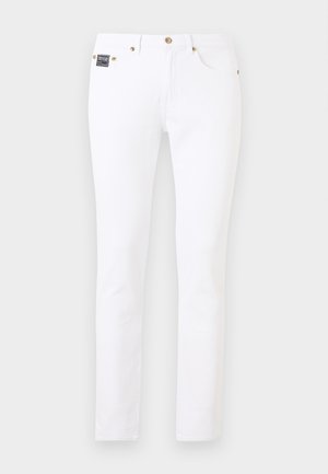 Jeans bianchi slim-fit con dettagli in oro su bottoni e rivetti, tasche frontali e piccolo patch nero con il marchio sul lato destro.