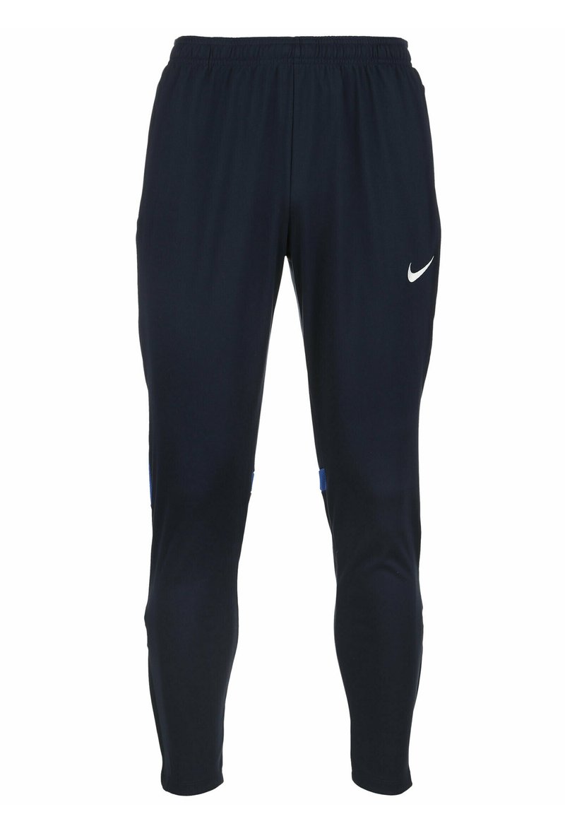 Nike Sporthosen aus dunkelblauem Stoff, mit schmaler Passform, elastischem Bund und einem weißen Logo auf der linken Hüfte. Blaue seitliche Akzente.
