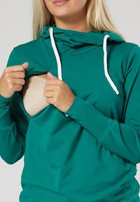 Teal-farbenes Hoodie mit langen Ärmeln und verstellbaren Kordeln, ausgestattet mit einem vorderen Reißverschluss und aus mittelschwerem, glattem Stoff.