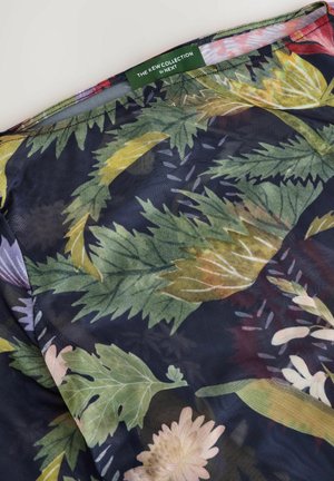 Sheer fabric showcasing a floral pattern with green leaves and light pink flowers on a dark background. Label reads "The New Collection by NEXT."