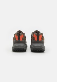 Brown and orange trail shoes featuring textured mesh and suede upper, reinforced heel, and rugged gray outsole with traction patterns.