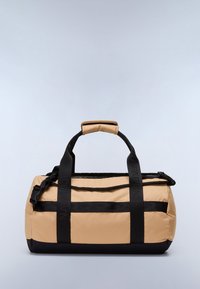 Sac de voyage en nylon beige et noir, doté de poignées doubles et d'une sangle ajustable. Texture lisse avec fermeture éclair latérale et détails de logo.