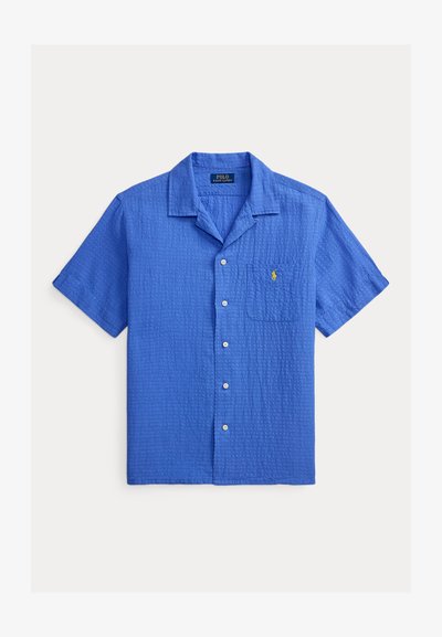 Chemise bleue à manches courtes avec boutons, col camp, poche poitrine et logo Polo Ralph Lauren jaune brodé.
