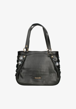 Borsa in pelle nera con applicazioni floreali sui lati, doppi manici e dettagli in hardware tono oro. Nome del marchio visibile nella parte inferiore.