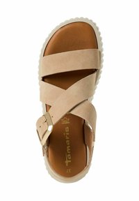 Beżowe zamszowe sandały z krzyżującymi się paskami, złotą klamrą i wyściełaną brązową wkładką. Posiadają białą falistą gumową podeszwę. Rozmiar 37.
