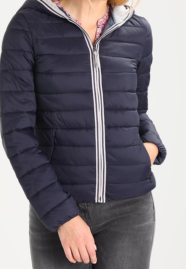 Padded navy jacket with horizontal stitching, gray hood lining, zip closure, and two side pockets. Soft texture and lightweight design.