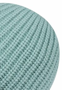 Round, knitted pouf in a soft pastel blue color. Features a textured, ribbed pattern and a slightly textured surface.