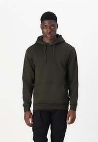 Dark green hoodie with a drawstring hood, ribbed cuffs, and a front pocket. Accessory details include flat laces and a smooth texture.