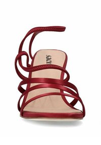 Red satin high-heeled sandal with multiple crisscross straps. Features a smooth, nude insole and a square open toe design.