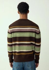 Striped sweater in brown, green, and cream colors; soft knit texture; classic crew neckline; ribbed hem and cuffs; relaxed fit.