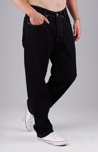 Black denim jeans with a loose fit, five pockets, visible stitching details, and copper rivets. Paired with white sneakers.