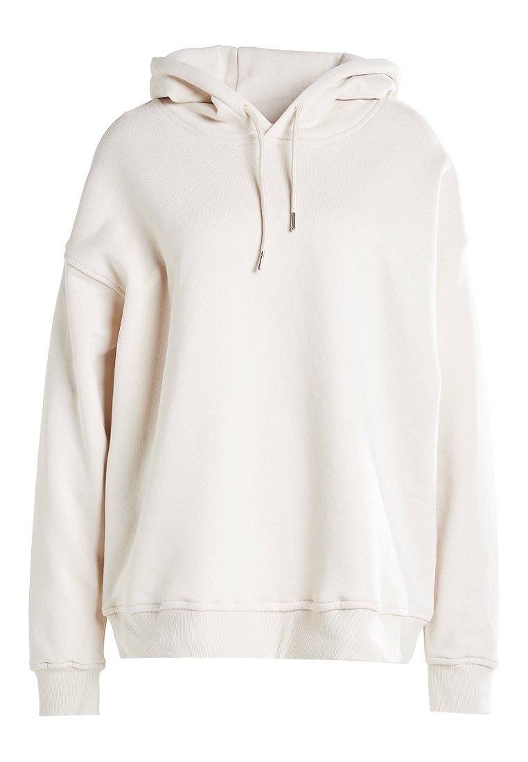 Felpa oversize color crema con cappuccio regolabile, maniche lunghe e polsini e orlo a coste, mostrata su uno sfondo bianco.