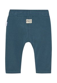 Niebieskie legginsy z bawełny z elastycznym paskiem w talii. Z tyłu metka z napisem "wejdź do mojego świata". Gładki, elastyczny materiał.