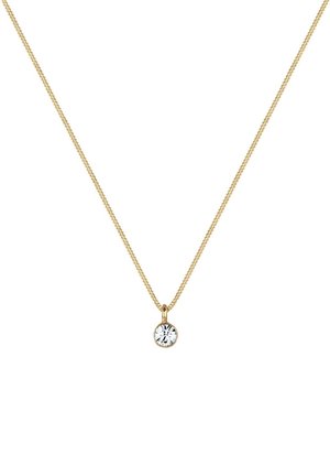 Collier chaîne en or avec un pendentif unique en pierre précieuse ronde transparente serti dans un chaton en or sur fond blanc.