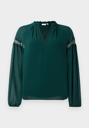 Dark green long-sleeve blouse with sheer sleeves, lace trim across upper arms, a ruffled neckline, and a V-shaped chest opening.