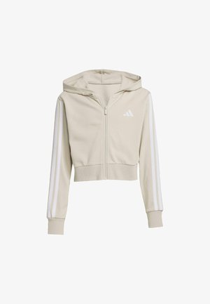 Sudadera con capucha corta en tela beige clara con cremallera frontal, tres rayas blancas en las mangas y un logo bordado en el pecho. Textura suave.