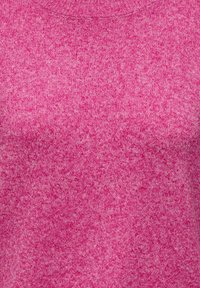 Gros plan sur un tissu tricoté rose pâle montrant une texture fine et un motif de tissage avec de légères variations de couleur.