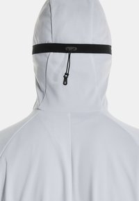 White hooded jacket featuring a textured fabric, black drawstring, and adjustable neck area. Smooth surface with subtle design details.