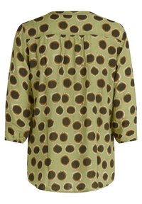 Zelená blůza s volným střihem, zdobená kulatým potiskem v hnědé a krémové. Dlouhé rukávy se elastickými manžetami a zadními sklady pro větší volnost.