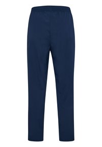 Marinblå träningbyxor, tillverkade av lätt material, med dragsko i midjan och tapered ben, med en jämn, matt yta.