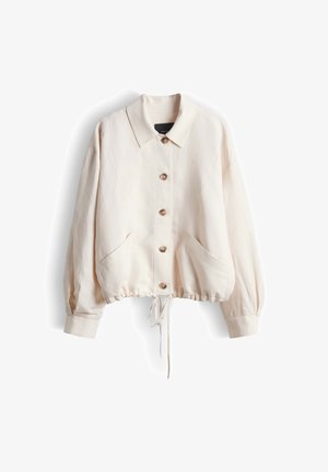 Light beige long-sleeve button-up jacket with collar, two front pockets, and adjustable drawstring hem.