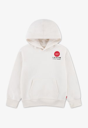 Σκούφας Levi's σε κρεμ χρώμα με τσέπη μπροστά, ribbed μανσέτες και μαύρο κείμενο "Levi's Living Legend" στο στήθος κάτω από μια κόκκινη κυκλική ετικέτα.