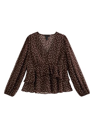 Brązowa bluzka w białe kropki z długimi rękawami, dekoltem w serek i gumką w talii typu peplum. Wykonana z miękkiego, prześwitującego materiału, z elastycznymi mankietami.