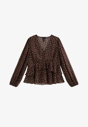 Blusa marrone a pois con maniche lunghe, scollo a V e vita a peplo. Presenta un tessuto morbido e trasparente con polsini elasticizzati.