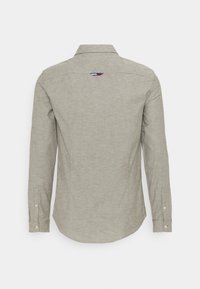 Gray long-sleeve shirt, made of textured fabric. Features a button-down collar, button cuffs, and a back loop detail with color accents.